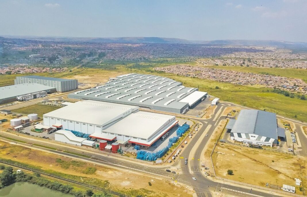 Aerial view of a South African special economic zone precinct with logistics and manufacturing buildings.